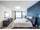 Comfortable main bedroom featuring a large bed, stylish furniture, and ample natural light at 1791 Hackberry St, Clermont, FL 34715