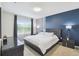 Modern main bedroom features an accent wall, and ample natural light creating a restful retreat at 1791 Hackberry St, Clermont, FL 34715
