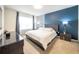 Comfortable main bedroom featuring a large bed, stylish furniture, and accent wall at 1791 Hackberry St, Clermont, FL 34715