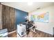 Stylish home office with dual monitors, wood accents, a world map, and natural light at 1791 Hackberry St, Clermont, FL 34715