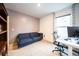 Bright office space with a comfortable couch, large window, and desk with computer setup at 1791 Hackberry St, Clermont, FL 34715