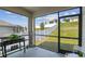Screened porch with grill and view of fenced yard at 1791 Hackberry St, Clermont, FL 34715