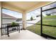 Cozy screened porch with grill and views of the well-maintained backyard at 1791 Hackberry St, Clermont, FL 34715