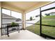 Cozy screened porch with grill and views of the well-maintained backyard at 1791 Hackberry St, Clermont, FL 34715