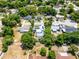 Charming home featuring a screened-in pool, solar panels, mature trees, and lush greenery at 1872 Wayside Dr, Orlando, FL 32818