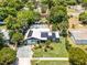 Aerial view of home showcasing the roof's solar panels, large yard, landscaping, and neighborhood at 1872 Wayside Dr, Orlando, FL 32818