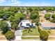 Beautiful home featuring a screened-in pool, solar panels, mature trees, and lush greenery at 1872 Wayside Dr, Orlando, FL 32818