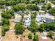 Charming home featuring a screened-in pool, solar panels, lush greenery, and mature trees at 1872 Wayside Dr, Orlando, FL 32818