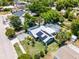 Aerial perspective of the property highlighting its landscaped yard, pool, and solar panels at 1872 Wayside Dr, Orlando, FL 32818