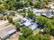 Charming home featuring a screened-in pool, solar panels, mature trees, and lush greenery at 1872 Wayside Dr, Orlando, FL 32818