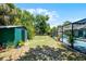 Backyard featuring a shed, pool enclosure, and ample green space at 1872 Wayside Dr, Orlando, FL 32818