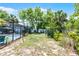 Well-maintained backyard featuring a pool enclosure, storage shed, and green space at 1872 Wayside Dr, Orlando, FL 32818