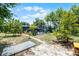 Spacious backyard showcasing mature trees, a pool enclosure, and outdoor living potential at 1872 Wayside Dr, Orlando, FL 32818