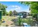 Lush backyard with a screened pool enclosure, patio area, and mature landscaping at 1872 Wayside Dr, Orlando, FL 32818