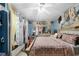 Spacious bedroom with ornate decor, a ceiling fan, and ample natural light at 1872 Wayside Dr, Orlando, FL 32818