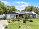 Charming single-story home featuring a well-manicured lawn and solar panels for energy efficiency at 1872 Wayside Dr, Orlando, FL 32818