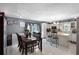 View of eat-in kitchen with center island and white cabinetry, along with dining table and chairs at 1872 Wayside Dr, Orlando, FL 32818