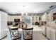 Spacious eat-in kitchen with center island, white cabinetry, and tile floor at 1872 Wayside Dr, Orlando, FL 32818