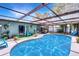Sparkling screened-in pool area with sun protection and comfortable seating, perfect for outdoor relaxation and entertainment at 1872 Wayside Dr, Orlando, FL 32818