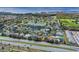 An aerial view shows a community with houses, ponds, and green spaces near a highway and lake at 1913 Lazy Oaks Loop, St Cloud, FL 34771