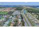An aerial view captures the neighborhood's layout, featuring a highway and a mix of residences at 1913 Lazy Oaks Loop, St Cloud, FL 34771