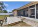 Backyard featuring a deck with seating and a screened-in patio at 1913 Lazy Oaks Loop, St Cloud, FL 34771