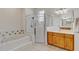 Bathroom with a glass shower enclosure, separate soaking tub and a wood vanity at 1913 Lazy Oaks Loop, St Cloud, FL 34771