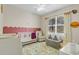 Bright Bedroom with whimsical decor, plush seating area, and a large window at 1913 Lazy Oaks Loop, St Cloud, FL 34771