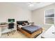 Bedroom with a ceiling fan, window, desk, and stylish gray and black bed set at 1913 Lazy Oaks Loop, St Cloud, FL 34771