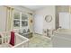 Cozy Bedroom featuring a crib, play area, storage, and a window with natural light at 1913 Lazy Oaks Loop, St Cloud, FL 34771