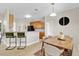 Eat-in kitchen with bar seating, granite countertops, and wood cabinetry provides a cozy dining space at 1913 Lazy Oaks Loop, St Cloud, FL 34771