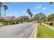 A community entrance with brick columns, lush landscaping, and palm trees for an inviting welcome at 1913 Lazy Oaks Loop, St Cloud, FL 34771
