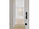 Hallway with wood-look tile flooring leading to a full bathroom with a soaking tub at 1913 Lazy Oaks Loop, St Cloud, FL 34771