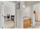 Hallway with a view to the bedroom, bathroom, and a wood vanity with a sink at 1913 Lazy Oaks Loop, St Cloud, FL 34771