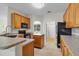 Bright kitchen showcases granite countertops, wooden cabinetry, stainless steel appliances, and an island at 1913 Lazy Oaks Loop, St Cloud, FL 34771