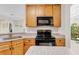 The kitchen boasts granite countertops, wooden cabinets, and modern appliances, perfect for cooking at 1913 Lazy Oaks Loop, St Cloud, FL 34771