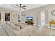 Comfortable living room with a sectional sofa, a glass coffee table, and a modern entertainment center at 1913 Lazy Oaks Loop, St Cloud, FL 34771
