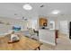 Open-concept living room and kitchen boasts a modern design, granite countertops, and stainless steel appliances at 1913 Lazy Oaks Loop, St Cloud, FL 34771