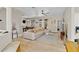 Bright living room area featuring a sectional sofa, entertainment center, and adjacent dining space at 1913 Lazy Oaks Loop, St Cloud, FL 34771