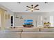 Inviting living room featuring a large sectional sofa, modern decor, and a view into other rooms at 1913 Lazy Oaks Loop, St Cloud, FL 34771