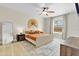 Serene bedroom with a ceiling fan, neutral tones, and a decorative rug offers a calming retreat at 1913 Lazy Oaks Loop, St Cloud, FL 34771