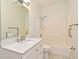 Bathroom featuring tub/shower combo with tile surround, white vanity with sink at 1947 Vienna Ave, Deltona, FL 32725