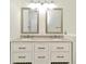 Bathroom featuring double vanity, granite countertop, modern bronze hardware, and white cabinets at 1947 Vienna Ave, Deltona, FL 32725