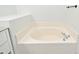 Bathroom featuring large soaking tub with tile surround and white wall paint at 1947 Vienna Ave, Deltona, FL 32725