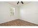Bright bedroom featuring wood-look floors and a window for natural light at 1947 Vienna Ave, Deltona, FL 32725