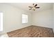 Bedroom with hardwood floors, neutral walls, ceiling fan with light fixture, and an abundance of natural light at 1947 Vienna Ave, Deltona, FL 32725