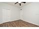 Bedroom featuring ceiling fan, wood look flooring, and white walls and trim at 1947 Vienna Ave, Deltona, FL 32725