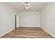 Simple bedroom with wood-look floors and a ceiling fan at 1947 Vienna Ave, Deltona, FL 32725