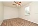 Bedroom featuring ceiling fan, window with blind, wood look flooring, and white walls at 1947 Vienna Ave, Deltona, FL 32725