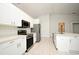 Kitchen with stainless steel appliances, white cabinets, and lots of open space at 1947 Vienna Ave, Deltona, FL 32725